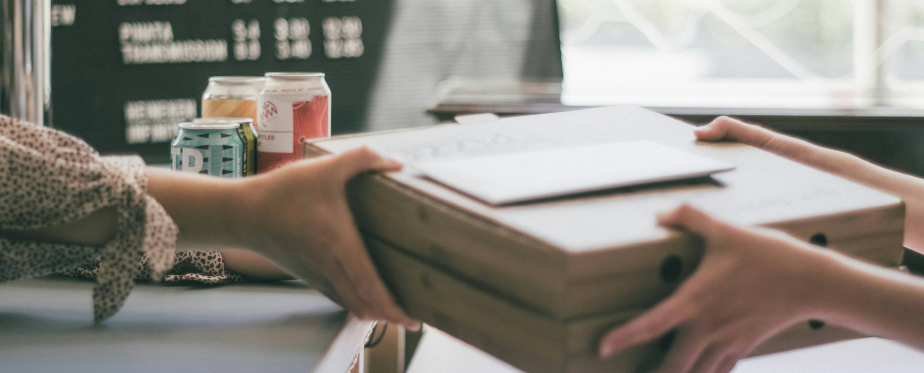 Person handing over a parcel to another person