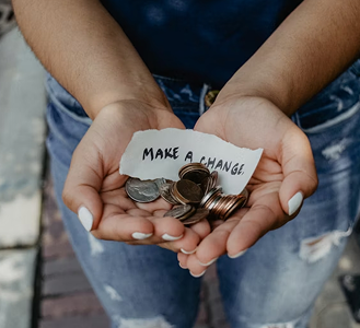 Hands holding donation box for community fundraising