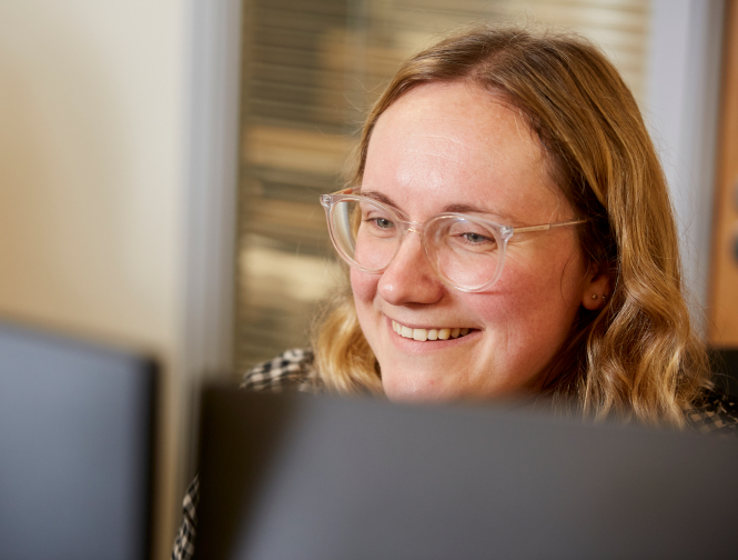 Business professional reviewing financial information on laptop