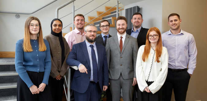 Business services team standing together in office