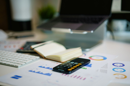 Financial planning documents and calculator on desk