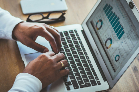 Finance professional analysing financial data on laptop