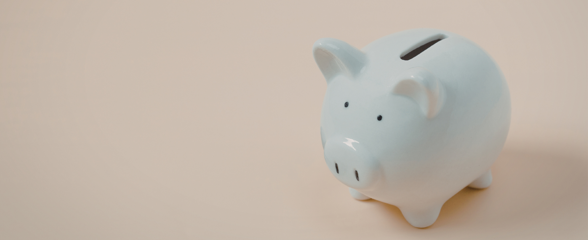 Blue piggybank on a cream background